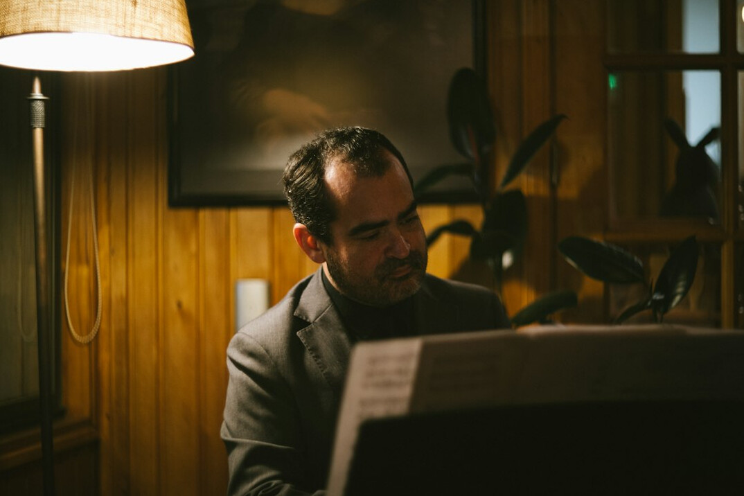 person reading newspaper in cafe